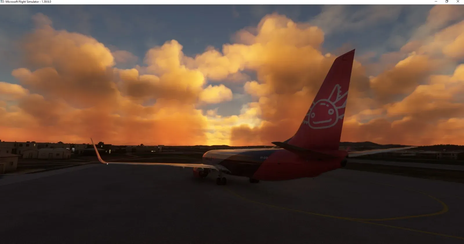 Tail of the Axolojet 737 against orange sunset clouds