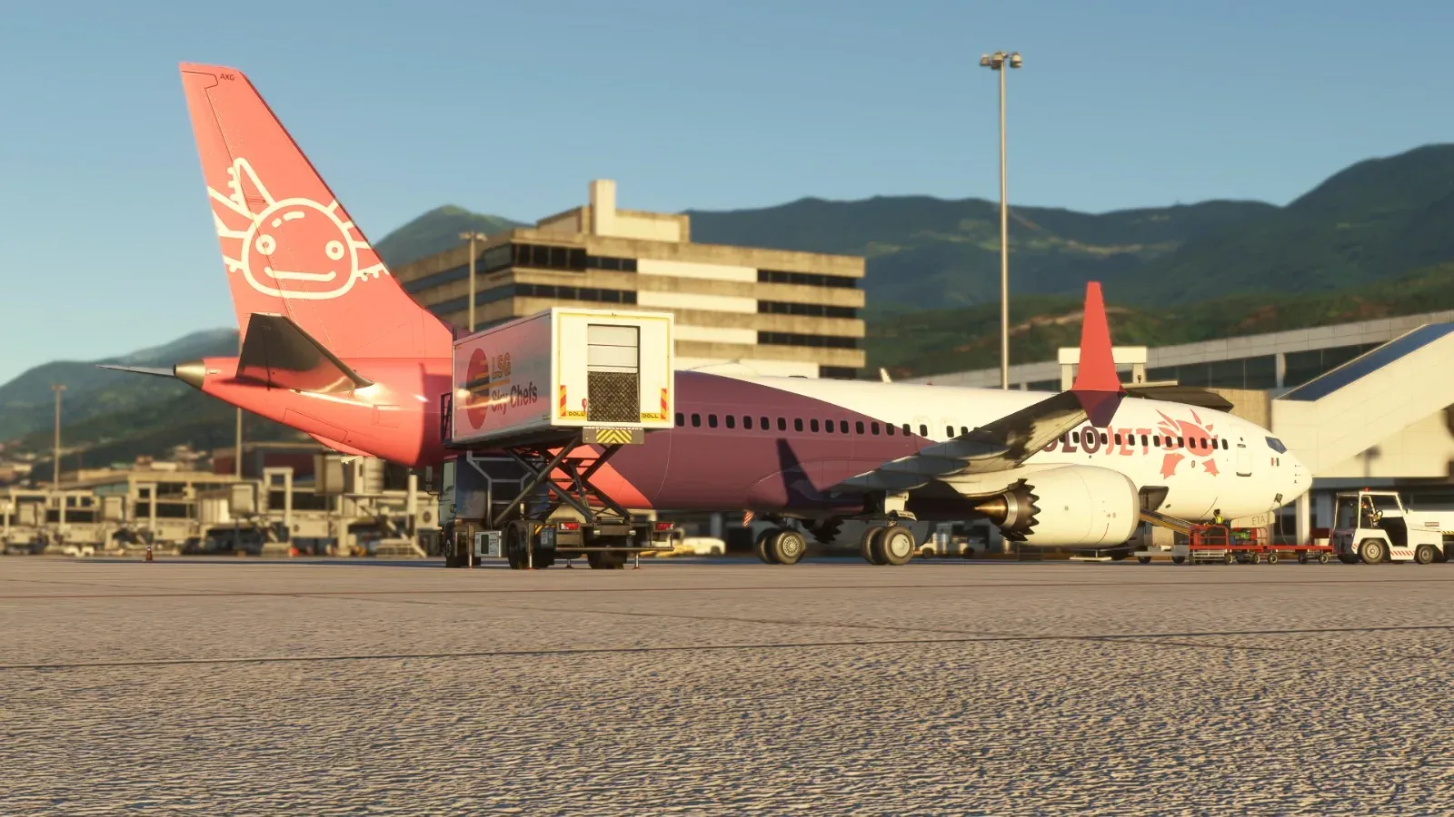 Tail of the Axolojet 737 with mountains behind