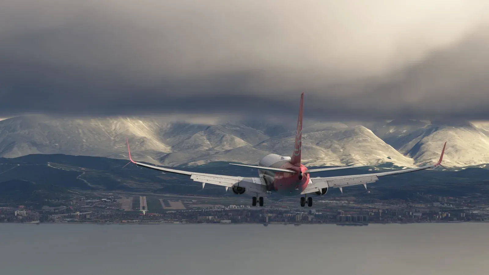 Axolojet Boeing 737 crossing the threshold with snowy mountains