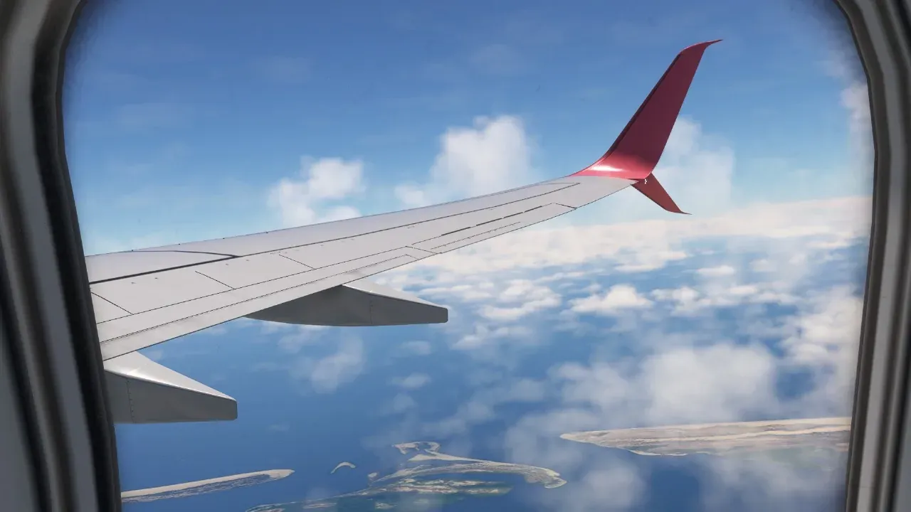 Axolojet 737 wing seen from the window over the coast