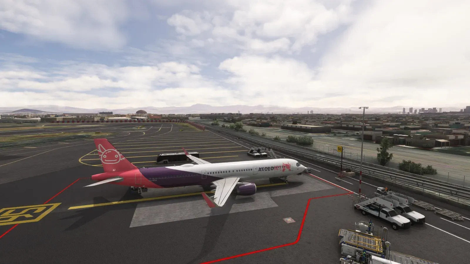 Axolojet Airbus A320 on the apron with the city behind